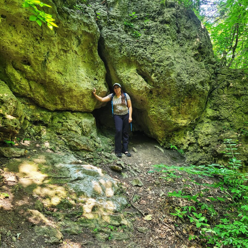 Jen in front of a small cave at Mississippi Palisades State Park
