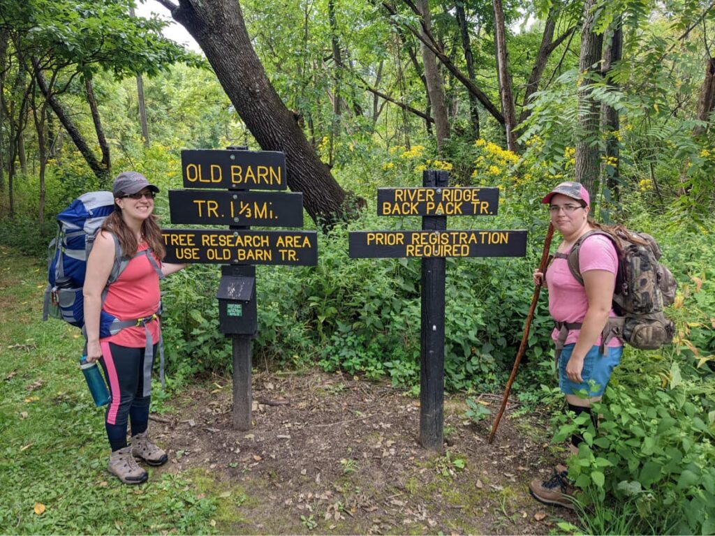 Jen and Liz in front of trail sign at Forest Glen Preserve