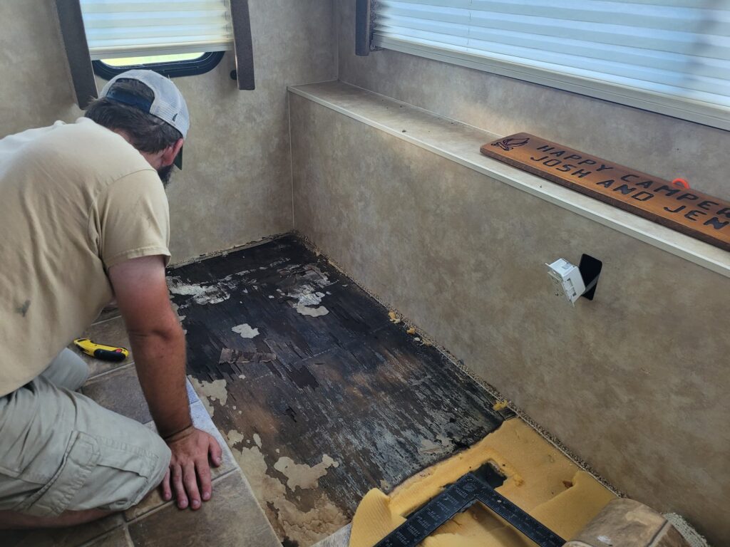 Photo of Josh looking at rotten rv subfloor