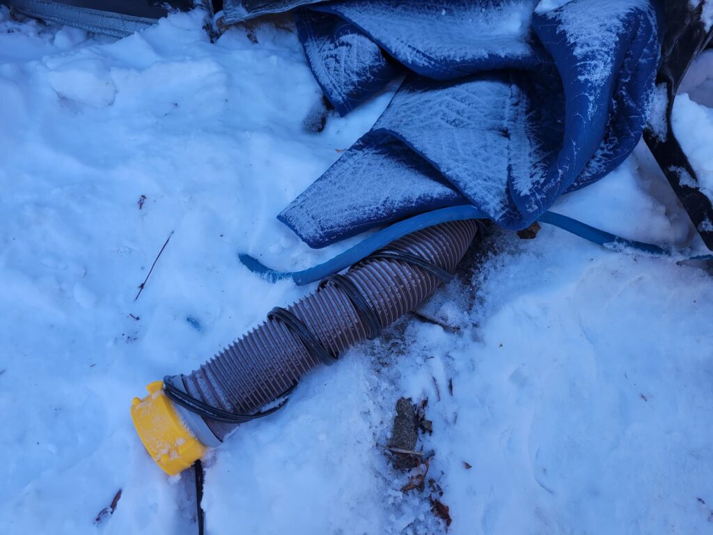 Photo of RV sewer hose with heated cable in winter