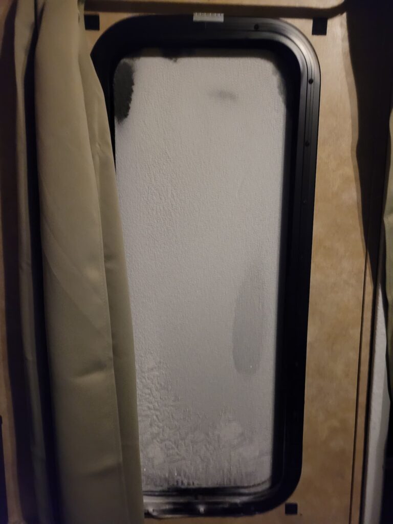 Photo of RV window frosted over in winter