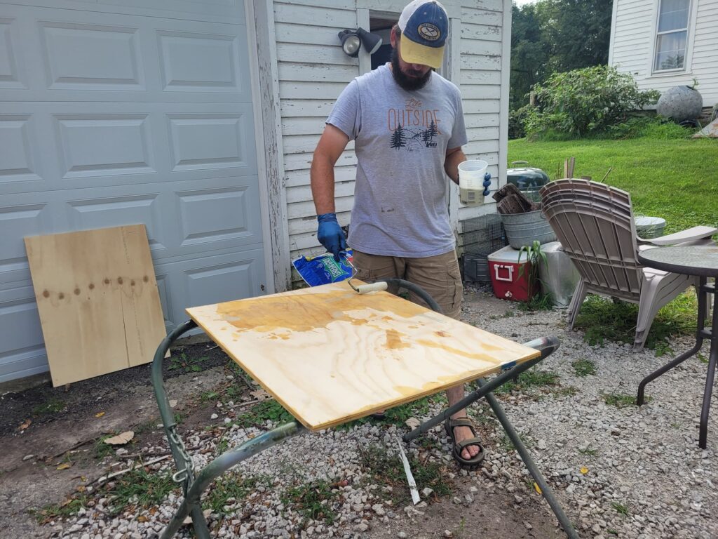 Photo of Josh adding epoxy to plywood