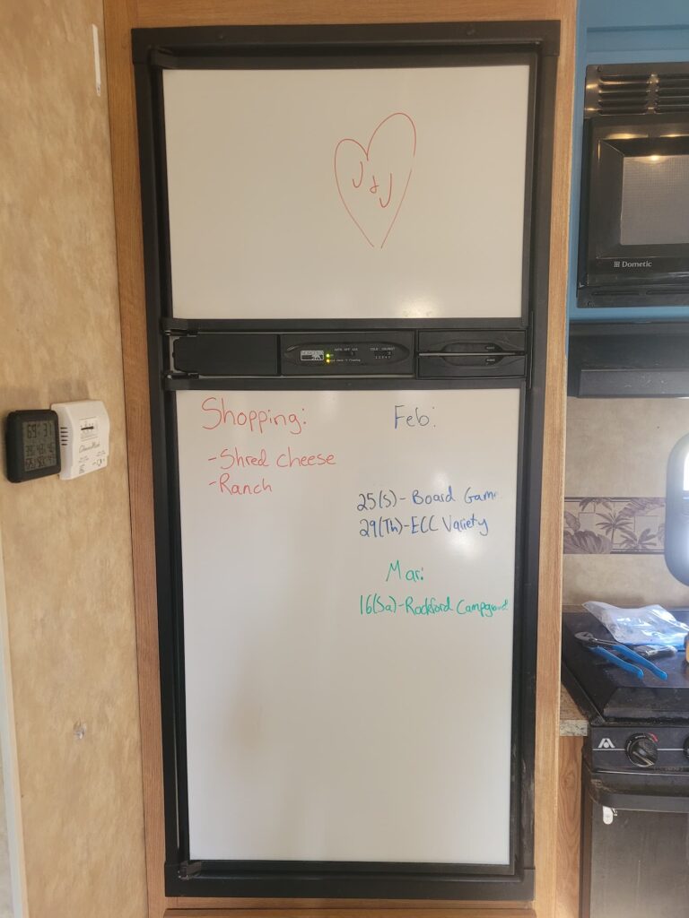 Photo of RV fridge with whiteboard front