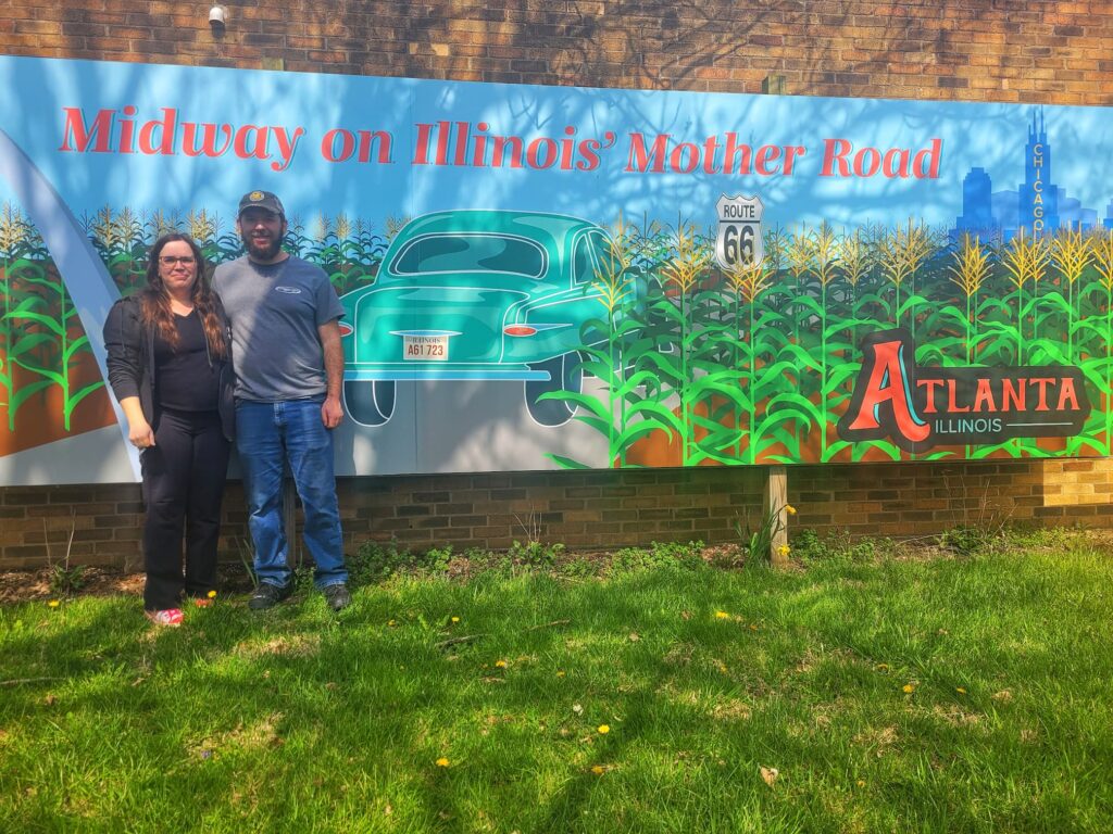 Photo of Josh and Jen in front of Atlanta Illinois Route 66 mural