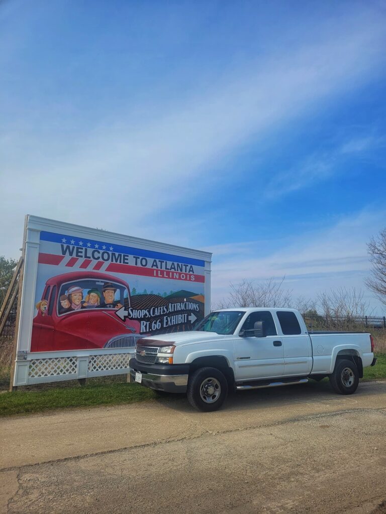 Photo of our truck in front of a route 66 billboard