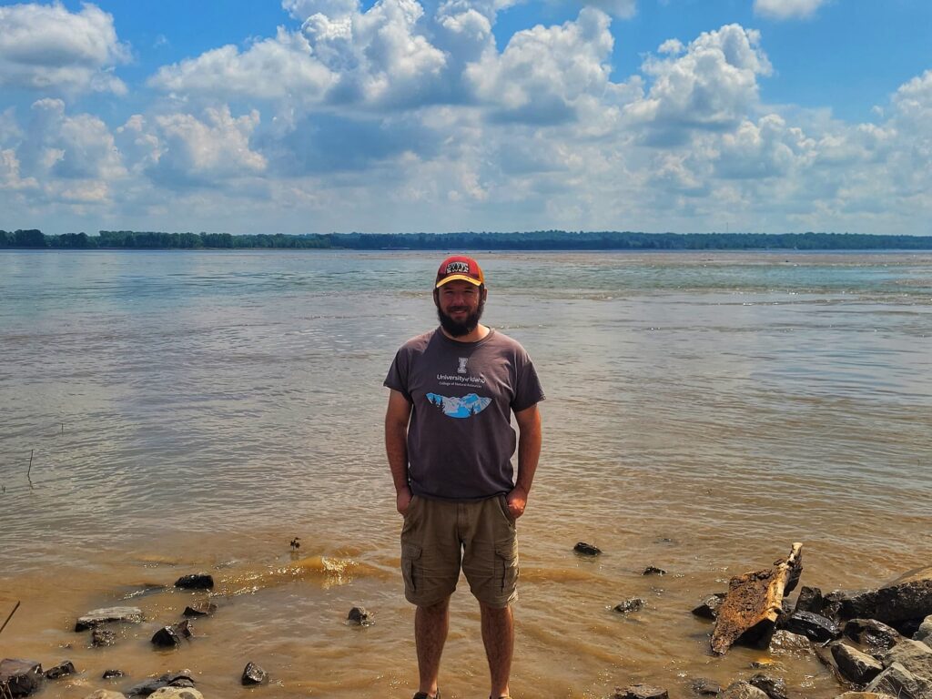 photo of Josh standing in mississippi and ohio river confluence