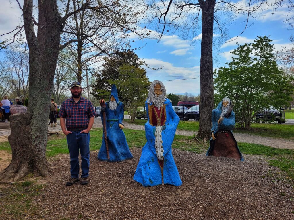 photo of Josh with wizard statues at Boo Castle Park