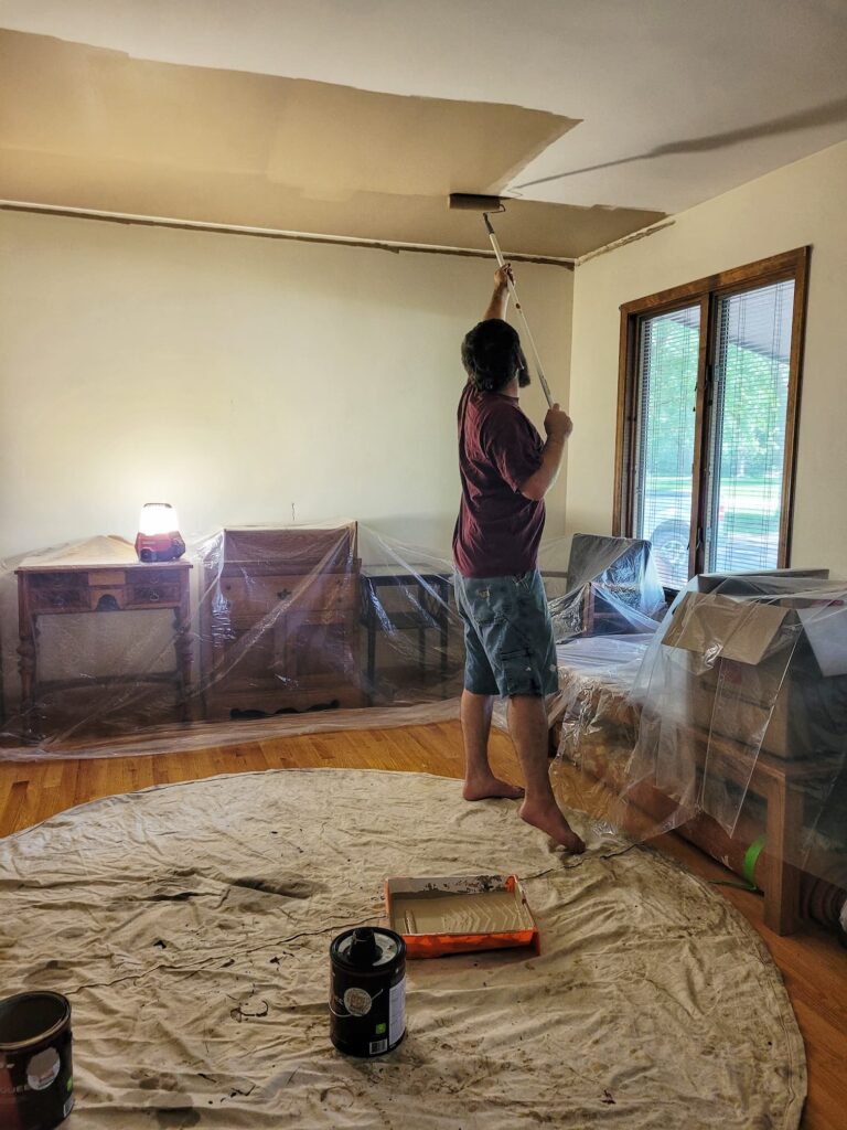 photo of Josh painting a ceiling