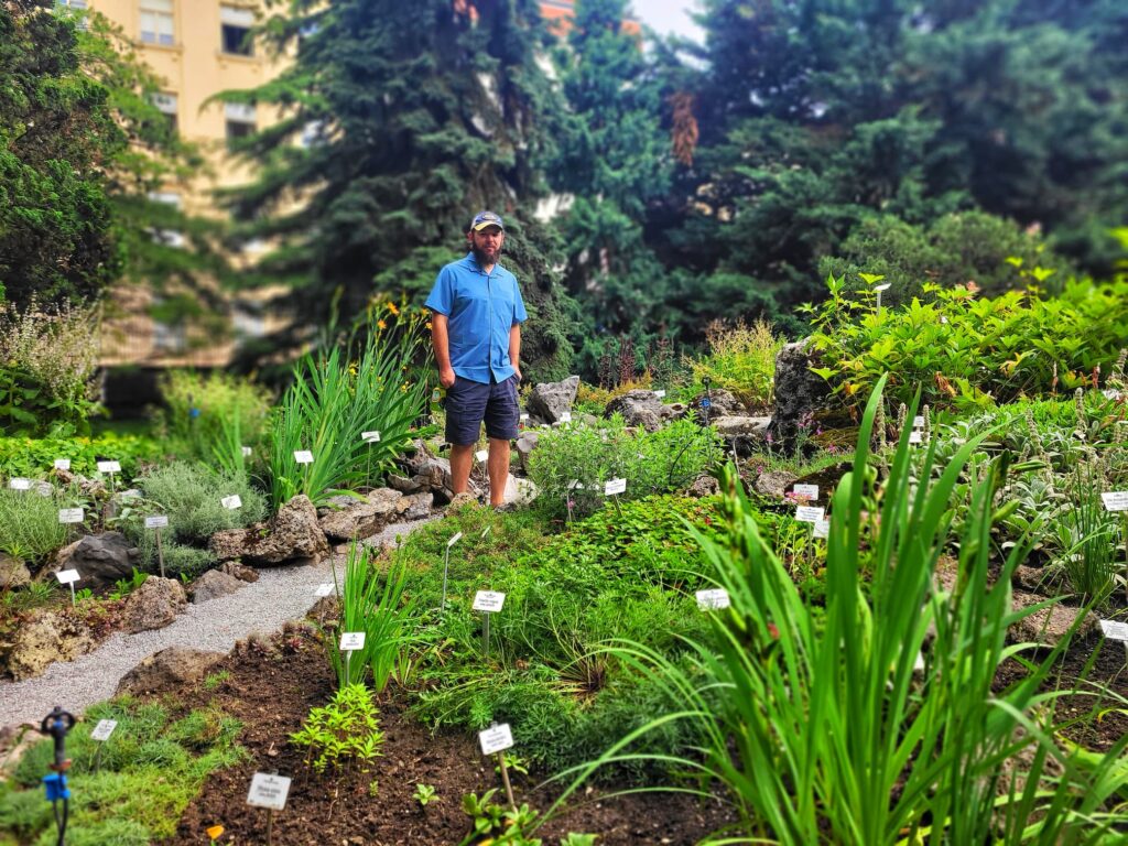 photo of Josh standing in a rockery garden at zagreb botanical gardens