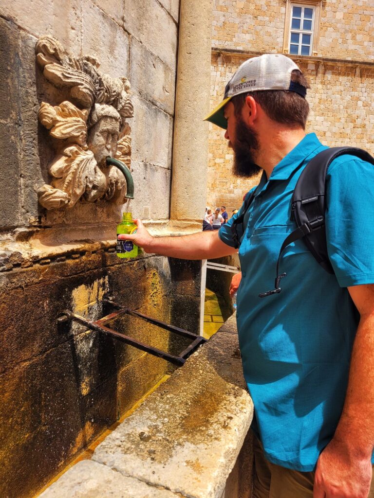 photo of Josh getting water at the onofrio fountain