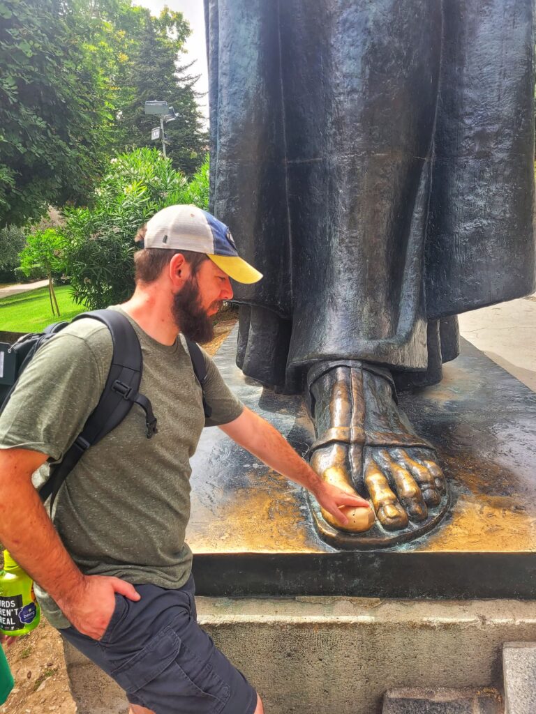 photo of Josh rubbing the lucky toe of gregory of nin