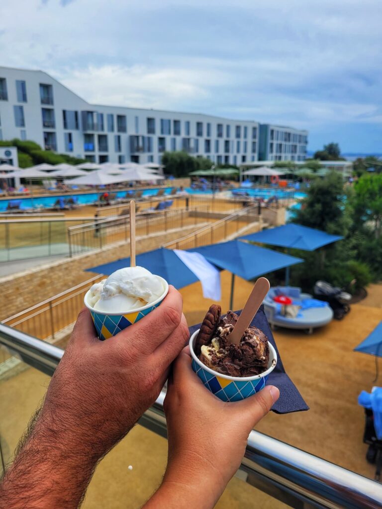 photo of us holding gelato in front of pool