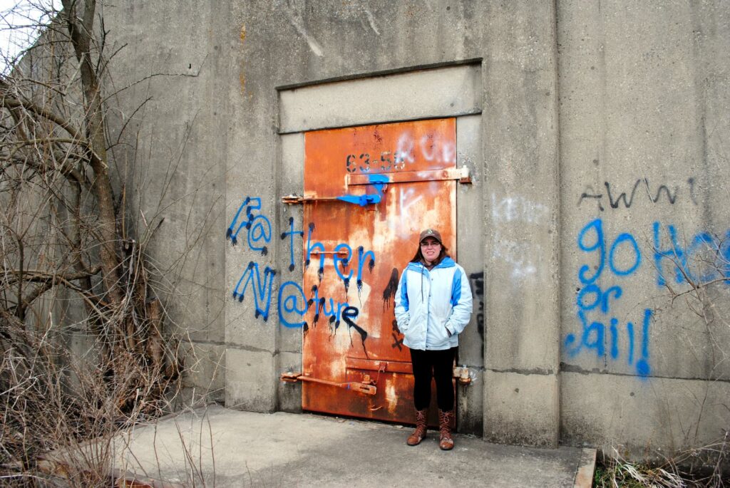 photo of jen in front of abandoned ammunitions bunker