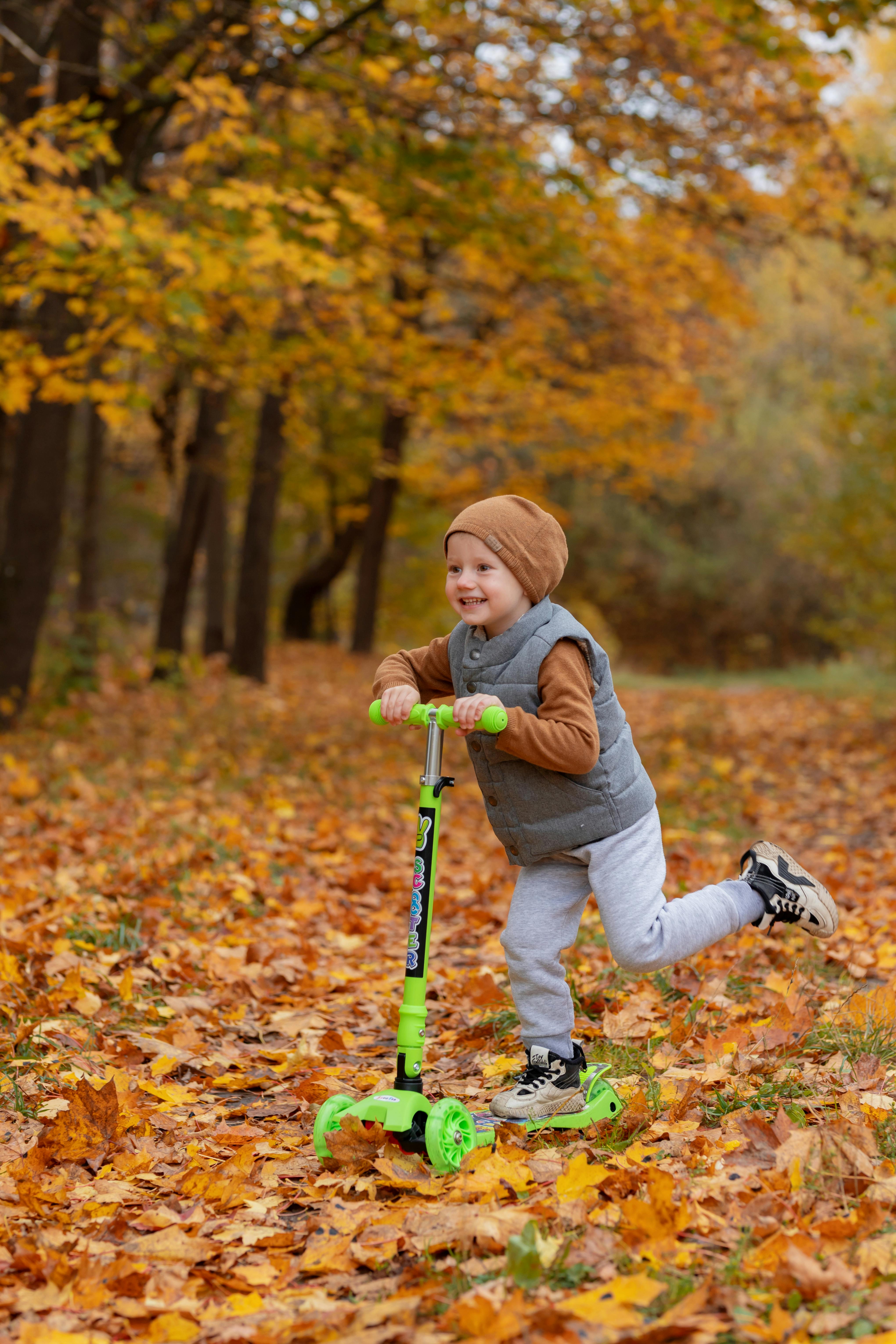 photo of kid on a scooter