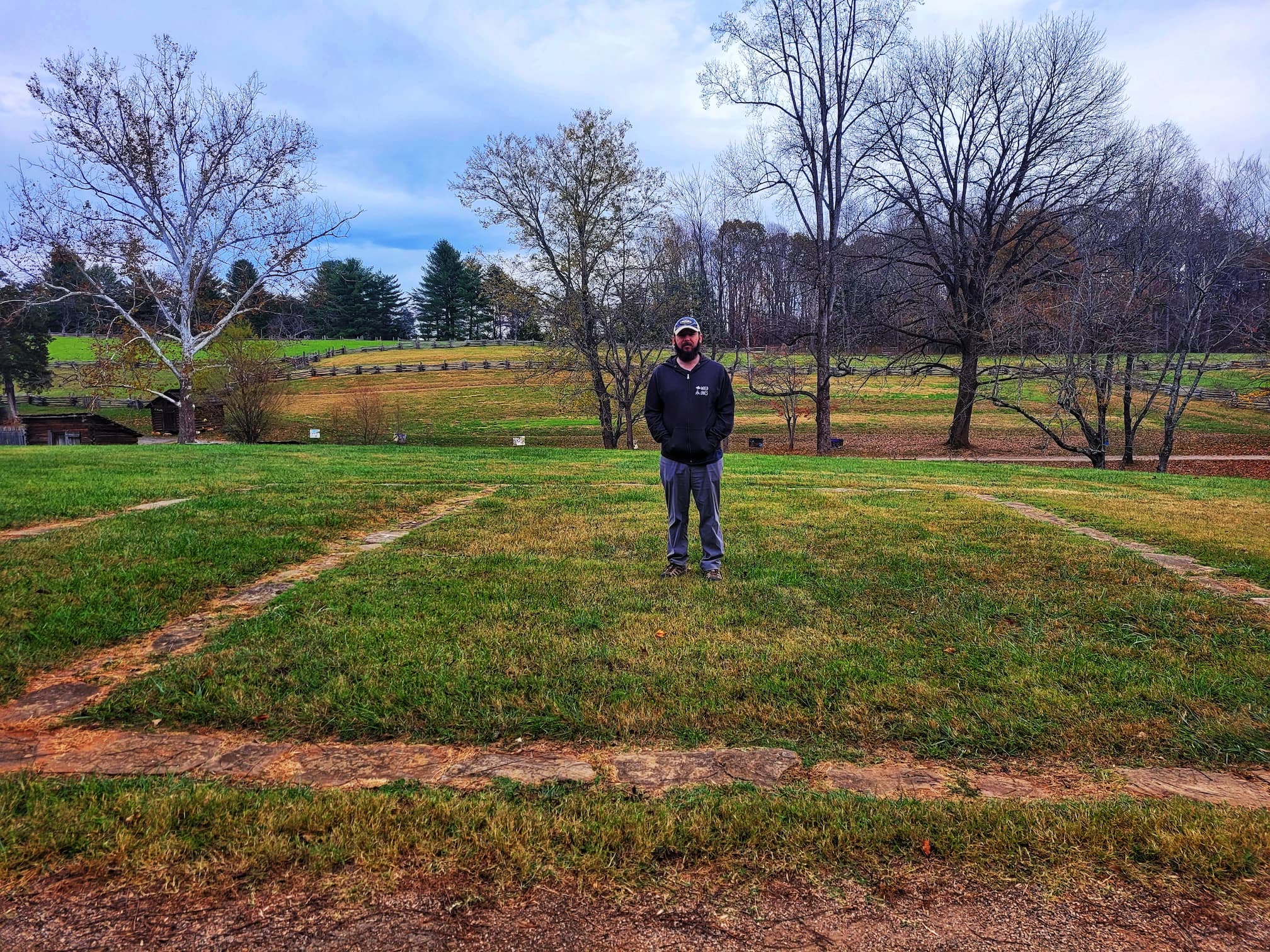 photo of josh standing in foundation outline of house at booker t washington national monument