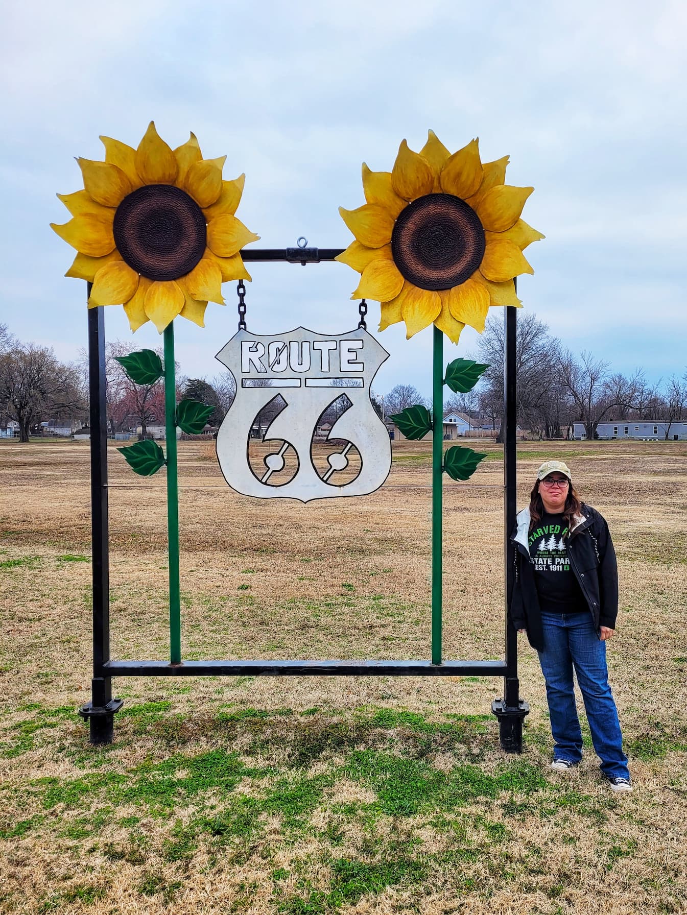photo of jen in front of route 66 sunflower sign