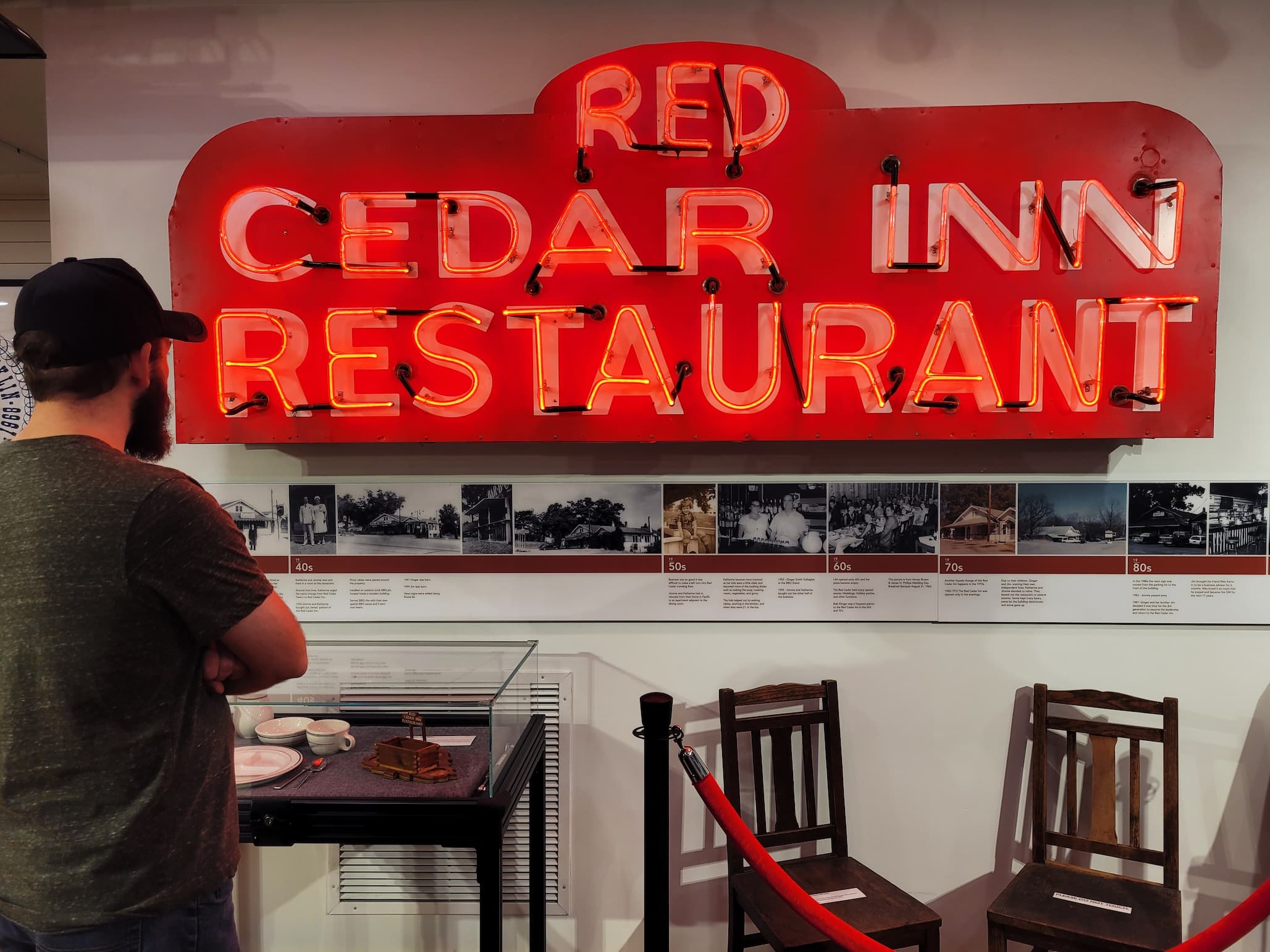 photo of josh in front of red cedar inn restaurant neon sign