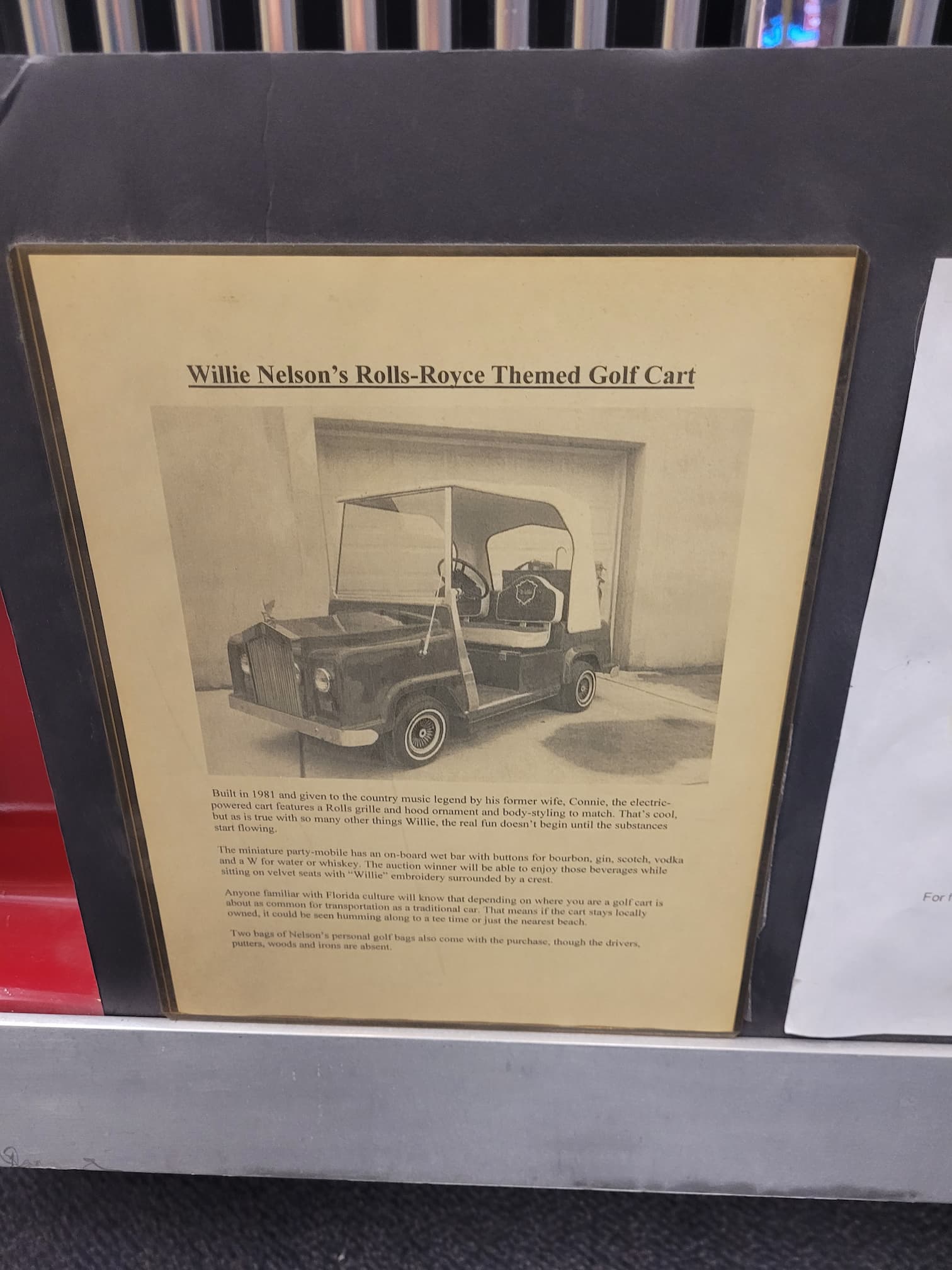 photo of sign about willie nelson's golf cart at route 66 ev museum