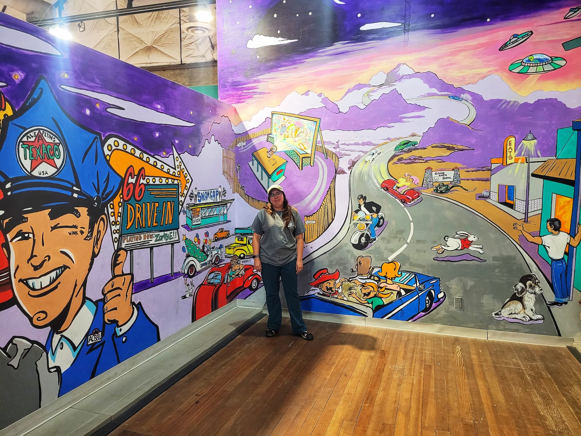 photo of jen in front of arizona route 66 museum mural