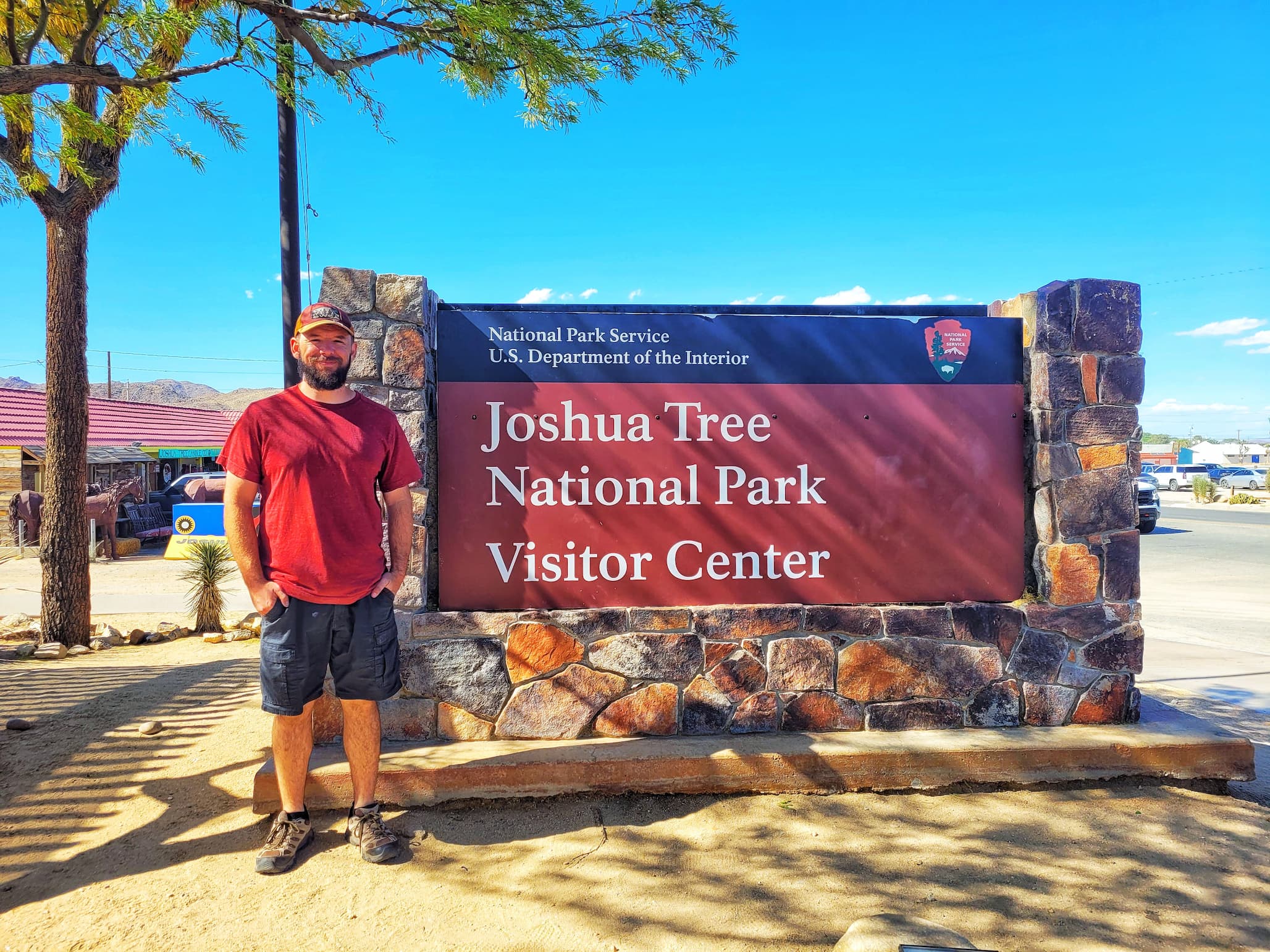 photo of josh in front of joshua tree national park sign